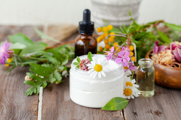 Concept of herbal, flower extracts in cosmetics. Natural organic ingredients, pure extract for beautiful healthy skin, essential oil, aromatherapy. Wooden background, close up