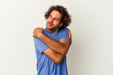 Young caucasian man isolated on white background hugs, smiling carefree and happy.
