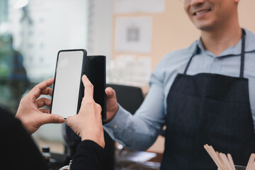 Customer using smartphone scan for payment in grocery store