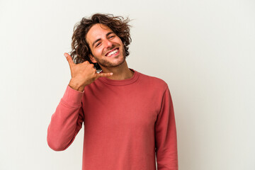 Young caucasian man isolated on white background showing a mobile phone call gesture with fingers.