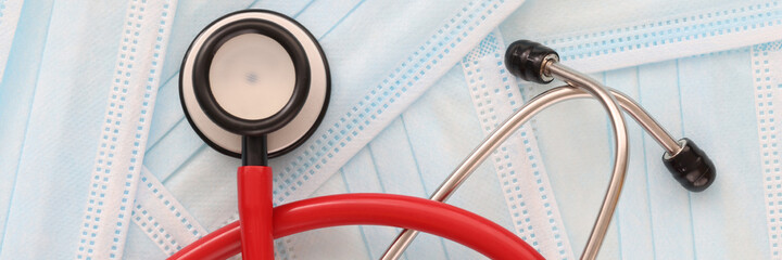 Stethoscope lies on medical protective masks closeup