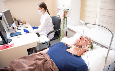 Patient brain testing using encephalography at medical center
