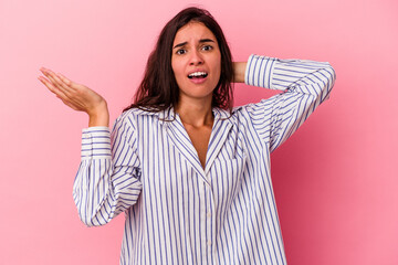 Young caucasian woman isolated on pink background screaming with rage.