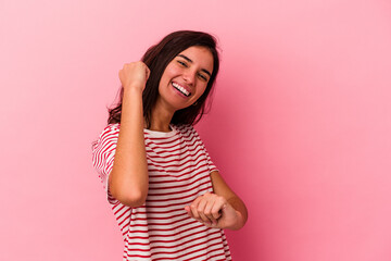 Young caucasian woman isolated on pink background cheering carefree and excited. Victory concept.