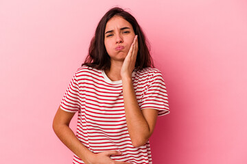 Young caucasian woman isolated on pink background blows cheeks, has tired expression. Facial...