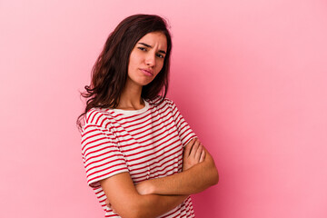 Young caucasian woman isolated on pink background unhappy looking in camera with sarcastic expression.