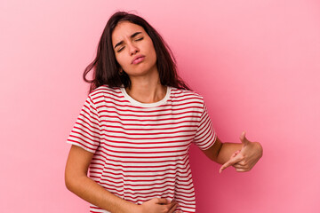 Young caucasian woman isolated on pink background having a liver pain, stomach ache.