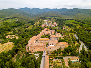 Aerial Drone view Bolgheri dall'alto, Viale dei Cipressi, cypress road and olive trees in Tuscany, Italy.