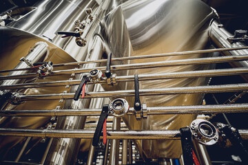 Rows of steel tanks for beer fermentation and maturation in a craft brewery
