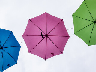 colourful umbrella in cloudy sky