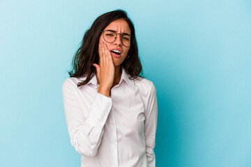 Young caucasian woman isolated on blue background yawning showing a tired gesture covering mouth with hand.