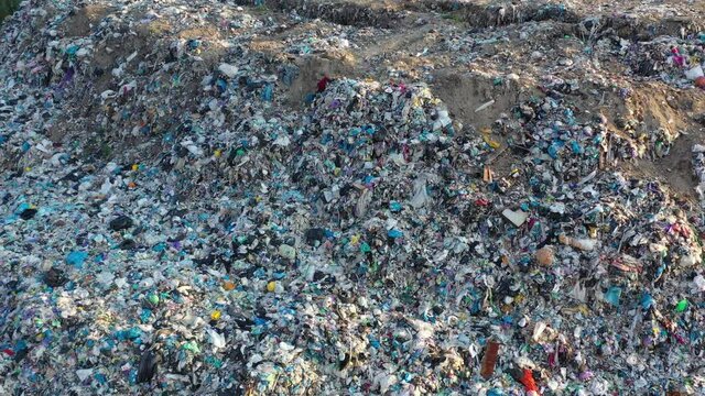 Aerial top drone view of large garbage pile, trash dump, landfill, waste from household dumping site, garbage background. Consumerism and contamination concept.