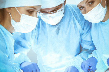 A group of surgeons is operating at the hospital. Health care concept