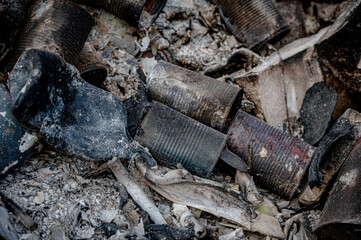 Obraz premium Food rubbish and tin cans burnt on a bonfire