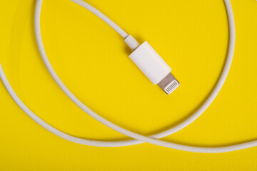 Lightning type Charger connector, for iPhone on yellow background