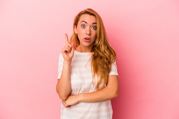 Caucasian blonde woman isolated on pink background having some great idea, concept of creativity.