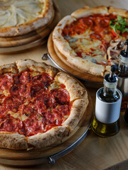 Pizza with meat pepperoni, tomato sauce, mozzarella cheese and Italian traditional spices with traditional dough and backed in oven. Copy space for restaurant menu text, selective focus.