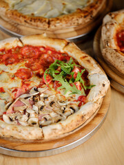 Pizza with meat pepperoni, tomato sauce, mozzarella cheese and Italian traditional spices with traditional dough and backed in oven. Copy space for restaurant menu text, selective focus.