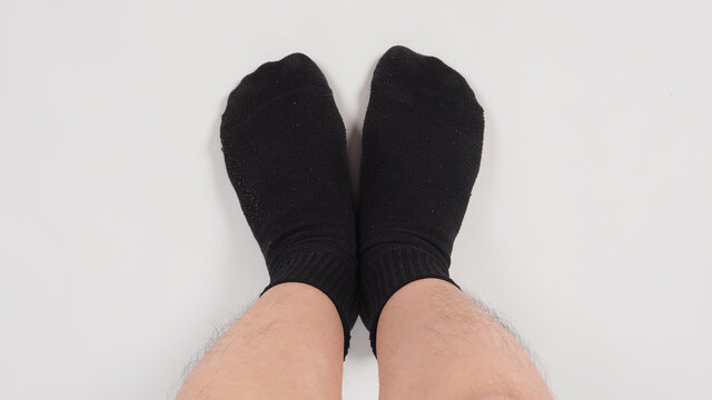 Asian leg and foot wear black sock on white background. isolated