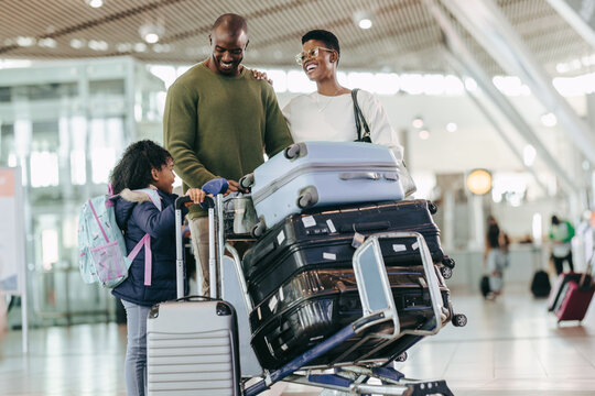 Young Family Waiting At Airport