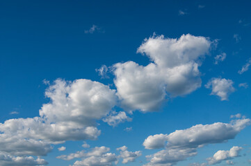 Naklejka na ściany i meble Blue sky with lots of thick clouds. Sky background.