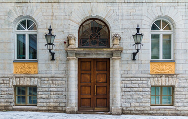 Fototapeta na wymiar Several windows and door on the facade of the urban historic building front view, Tallinn, Estonia 