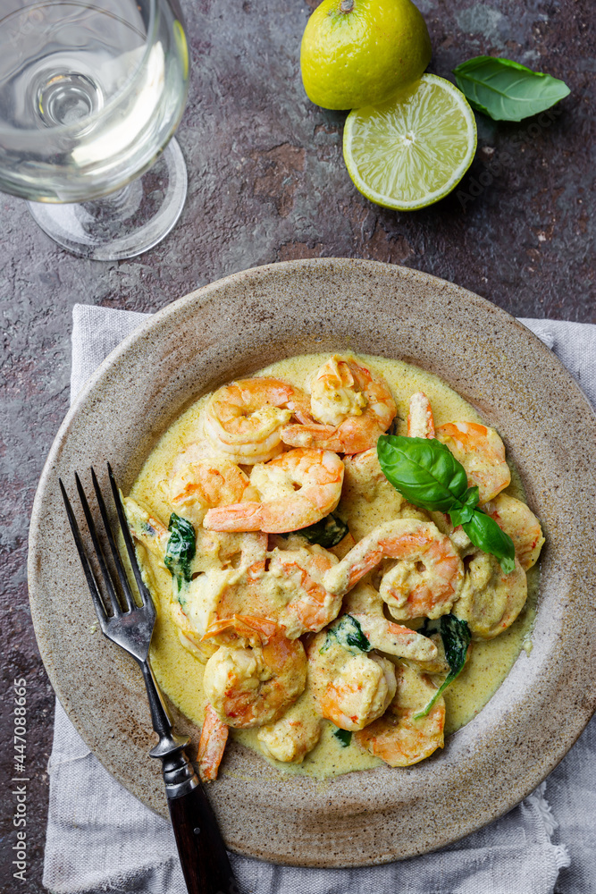 Sticker shrimps in cream sauce with coconut milk on a plate, top view or view from above, flat lay