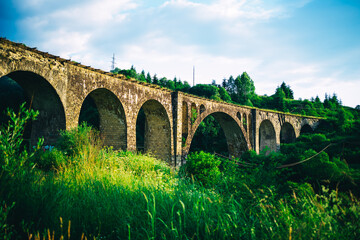 ancient stone viaduct in the rays of the setting sun