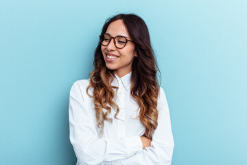 Young mexican woman isolated on blue background smiling confident with crossed arms.