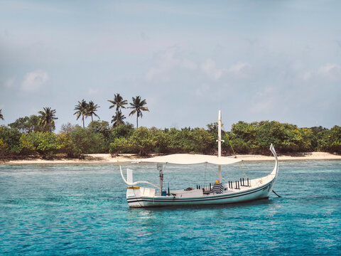 Traditional boat near tropical beach, Maldives