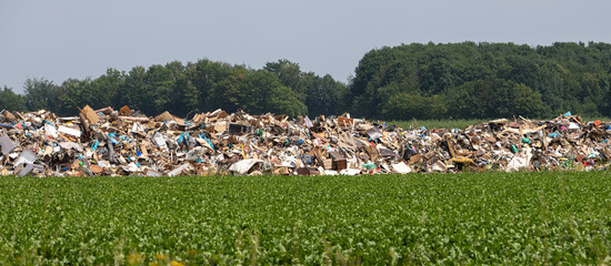 huge pile of bulky waste in a field after a flood disaster