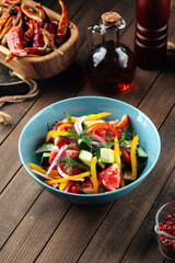 Fresh garden vegetables salad mix on a wooden background