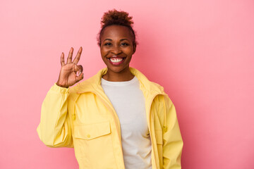 Young african american woman isolated on pink background cheerful and confident showing ok gesture.