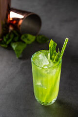 refreshing and light basil summer cocktail with ice cubes