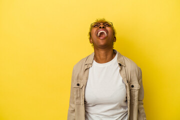 Young african american woman isolated on yellow background shouting very angry, rage concept, frustrated.