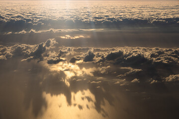 Aerial view of magic clouds during sunrise, shadow of clouds on the sea, sky view 