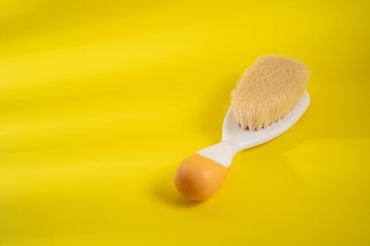 Comb baby's hair on a yellow background