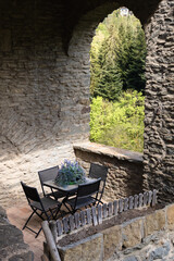 Cosy balcony with table in the old medieval stone house, Rupit, Catalonia, Spain