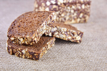 Dark rye sliced bread with whole seeds on top.