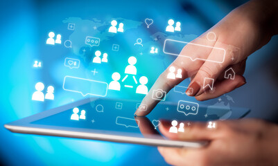 Close-up of a hand using tablet, social media concept