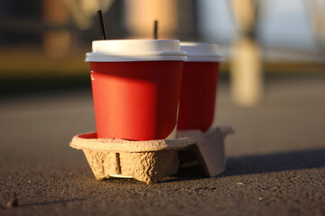 red cup of coffee on the asphalt