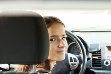 driving training, student driver in a driving school at a driving lesson behind the wheel of a...