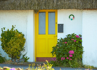 Fototapeta na wymiar View of brightly Irish house front with traditional colored england entrance door.