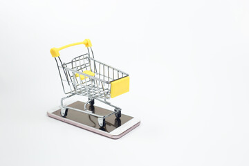 Shopping cart on smartphone white background. Shopping online supermarket on internet. business sale purchases digital marketing.