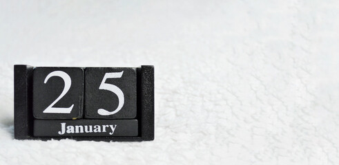 Wooden calendar from blocks on white background with copy space. 25th of January