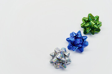 Set of three shiny bows for gifts on a white background with copy space