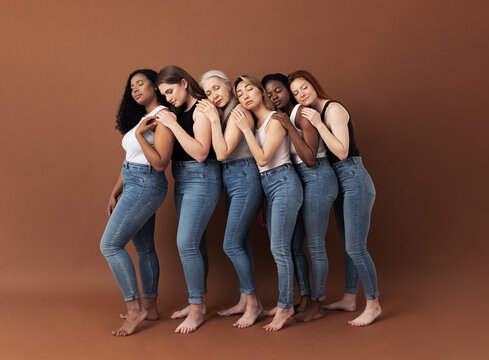 Full length of six women stands one after another with closed eyes. Side view of diverse females embracing each other.