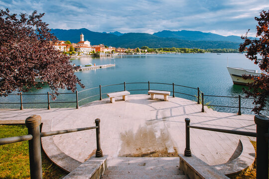 Feriolo, Verbania / Italy - June 2021: Feriolo village on Lake Maggiore with cloudy sky and steps to walk along the lake in the foreground