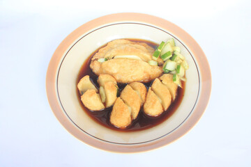 A plate of Palembang empek empek. Food with sour soy sauce sauce