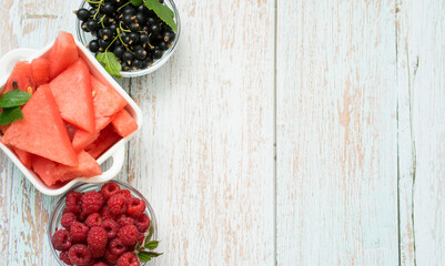 Assorted summer berries in bowls on the table